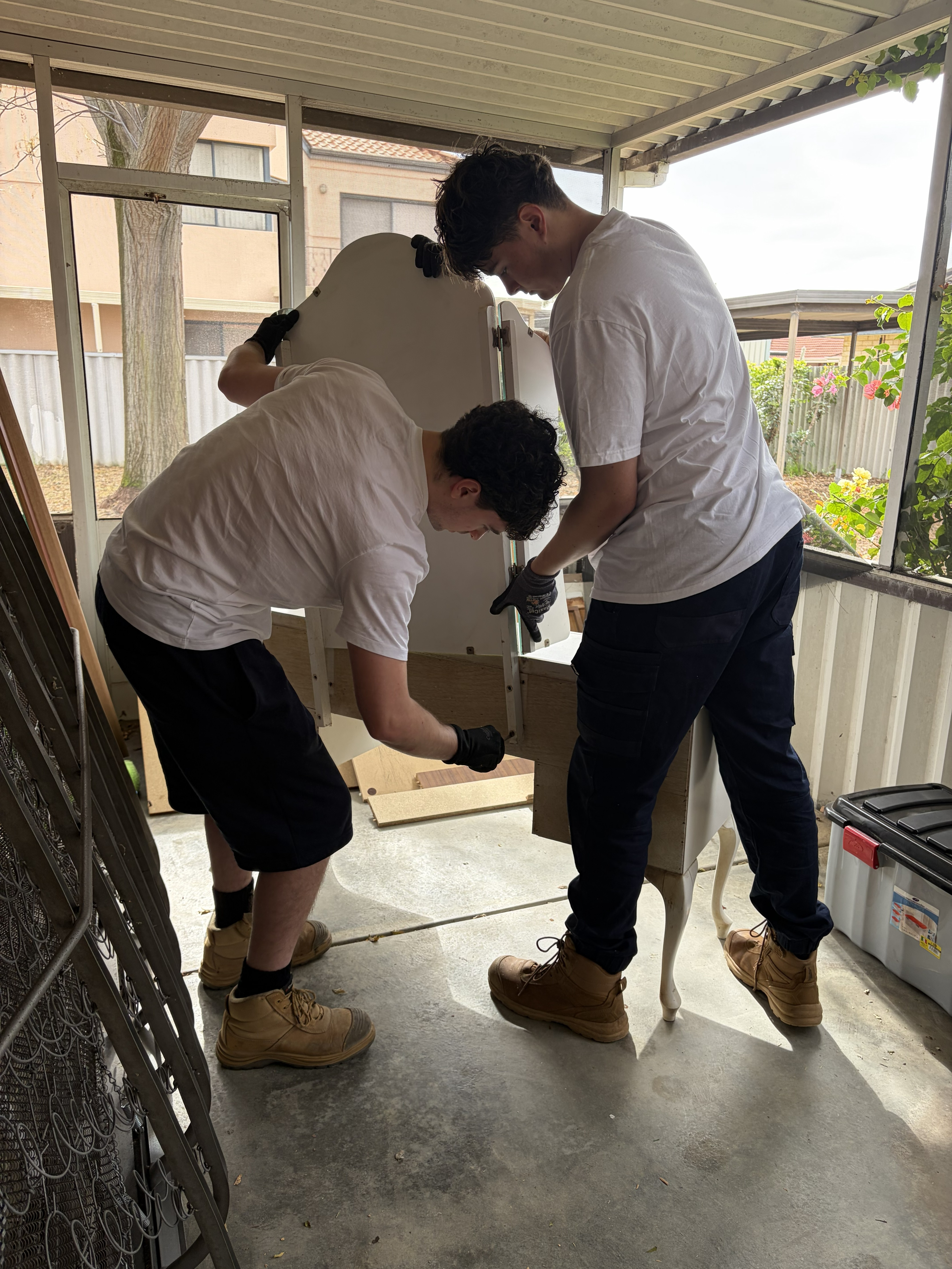 Junk Hustlers team preparing furniture for safe transport in Perth